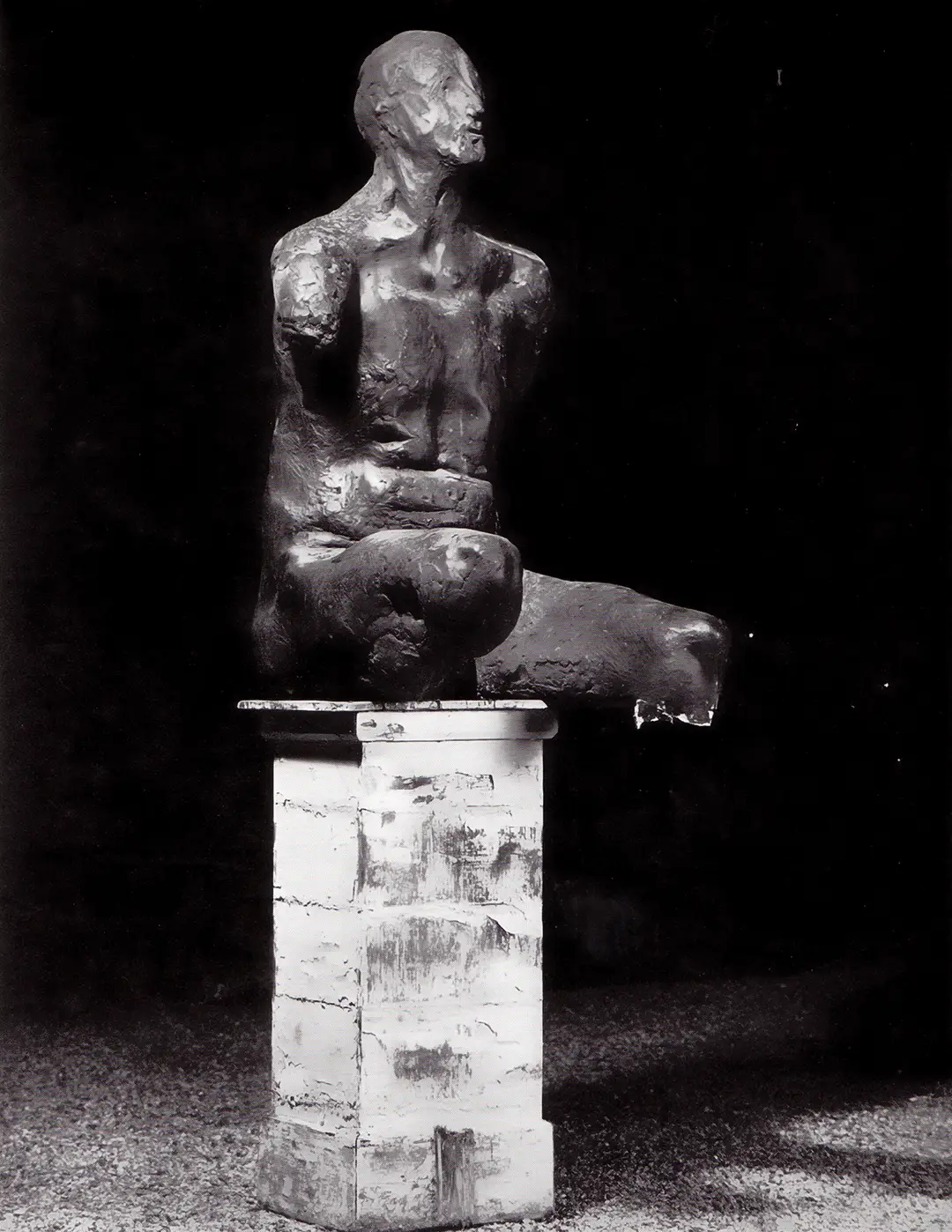 Seated figure mounted outside at night
