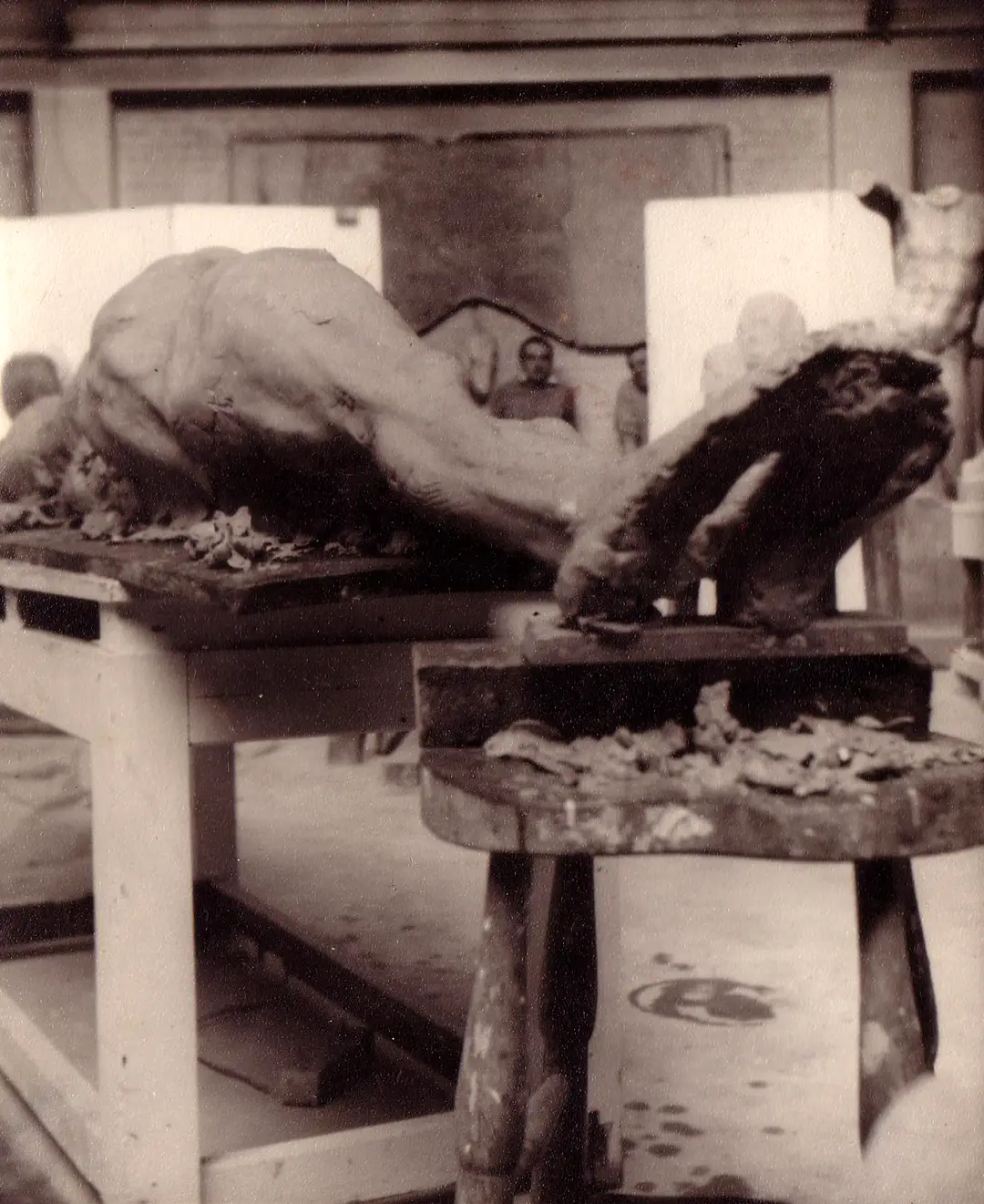 Roy and James Butler in the background behind a half-finished reclining clay figure in the ‘stone room’ at City and Guilds Institute.