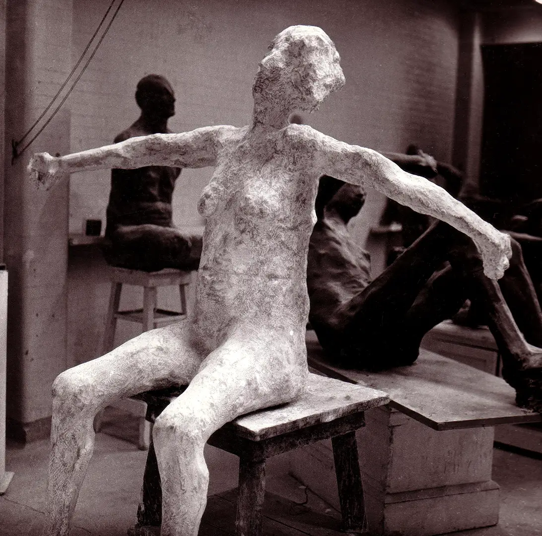 Seated figure with arms stretched