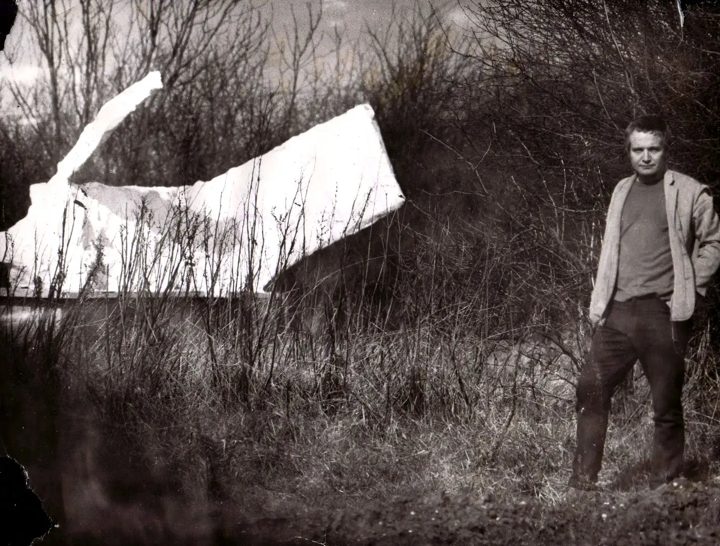 Roy Noakes standing in an Essex field with the sculpture Figure