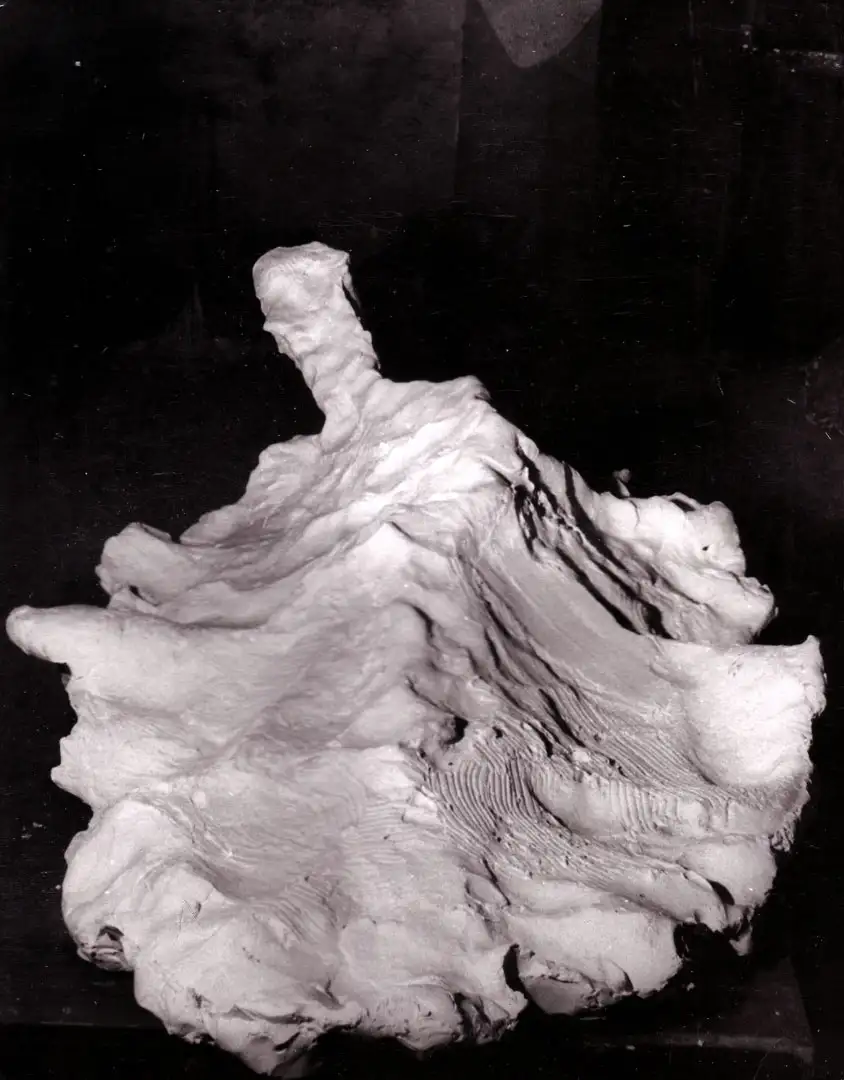 A Figurative sculpture shot from above in black and white on a black background