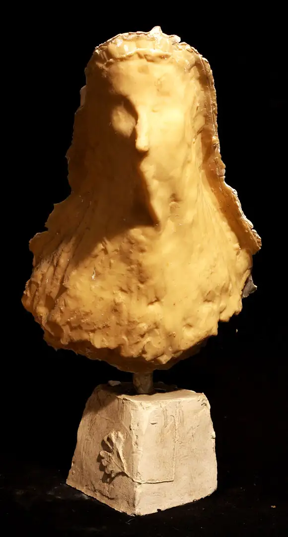 A wax bust cast in wax, mounted onto a wooden base