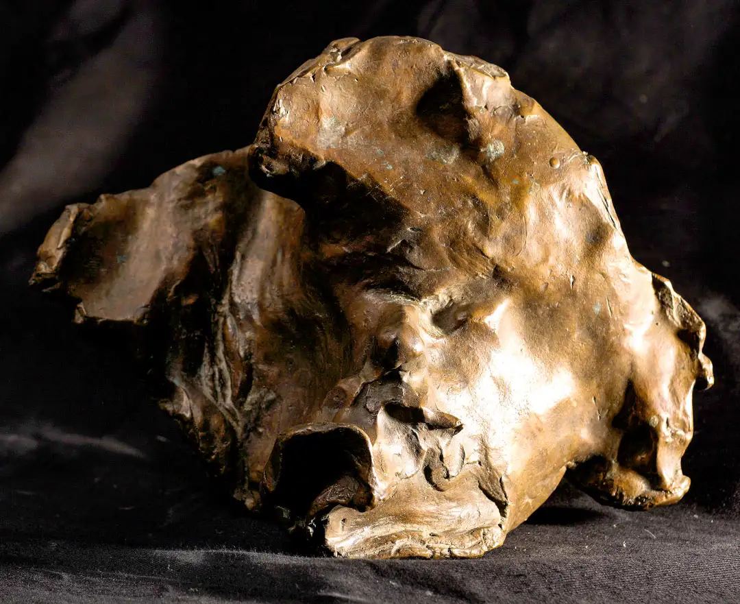 A bronze portrait of Kirk Huffman