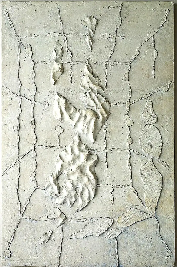 An abstract relief of a swimmer cast in resin