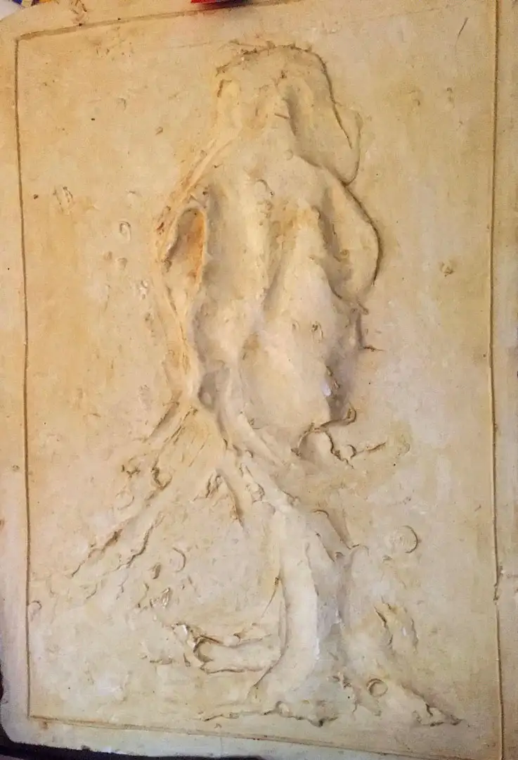 A relief of a standing figure cast in plaster