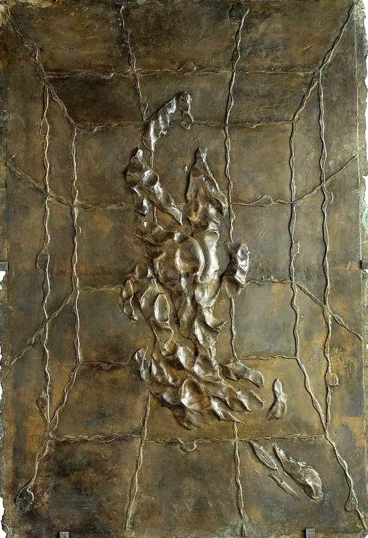 A relief of a swimmer cast in bronze