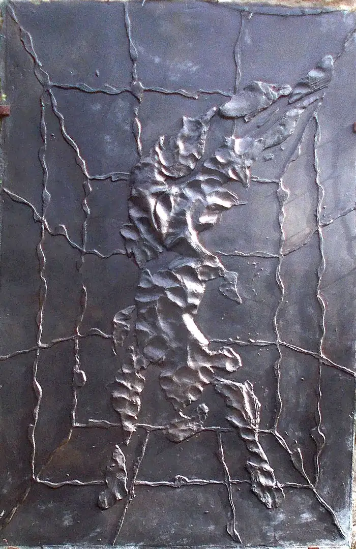 A relief of a swimmer cast in bronze