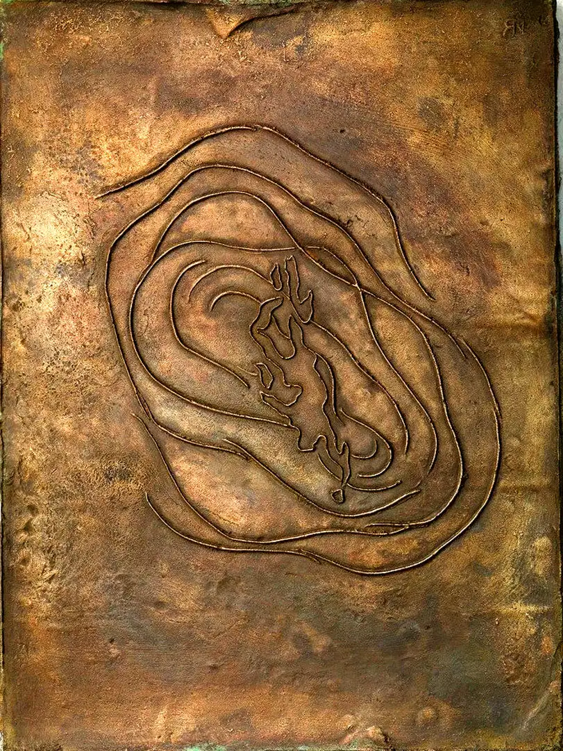 A relief of a swimmer cast in bronze