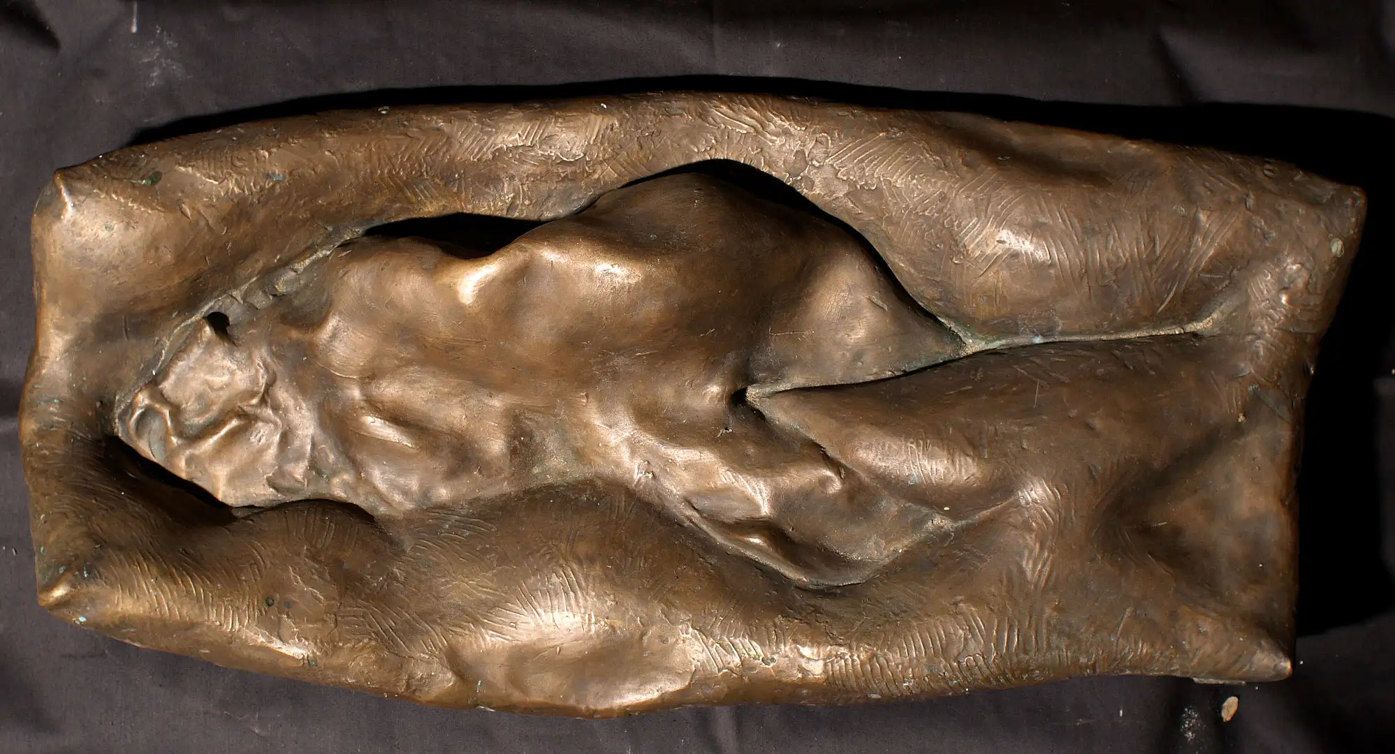 Figure enveloped in waves, relief in bronze