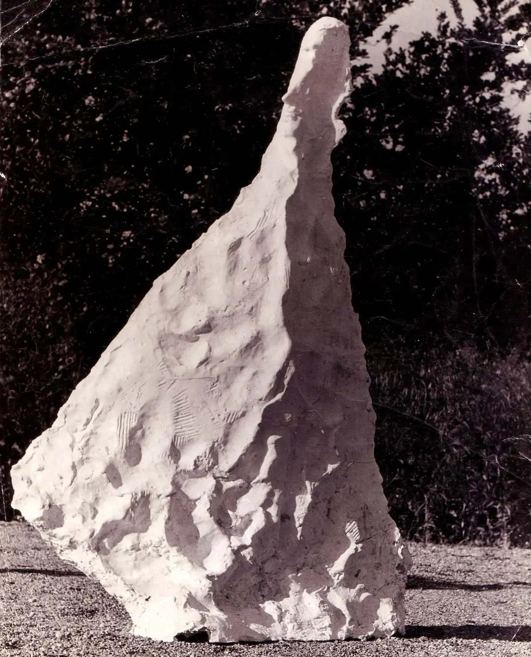 A plaster sculpture sitting in a field