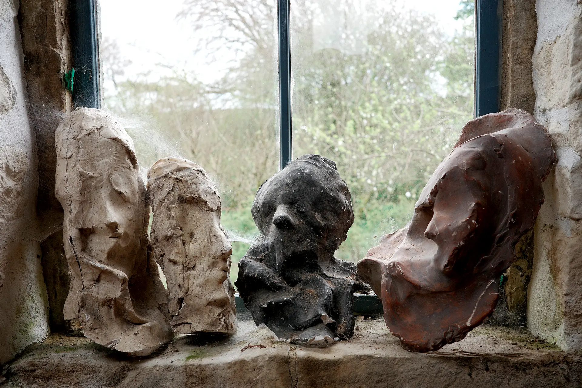 Four heads on a windowsill